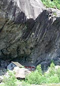 houses under overhanging cliffs