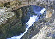 waterfall coming under the old bridge